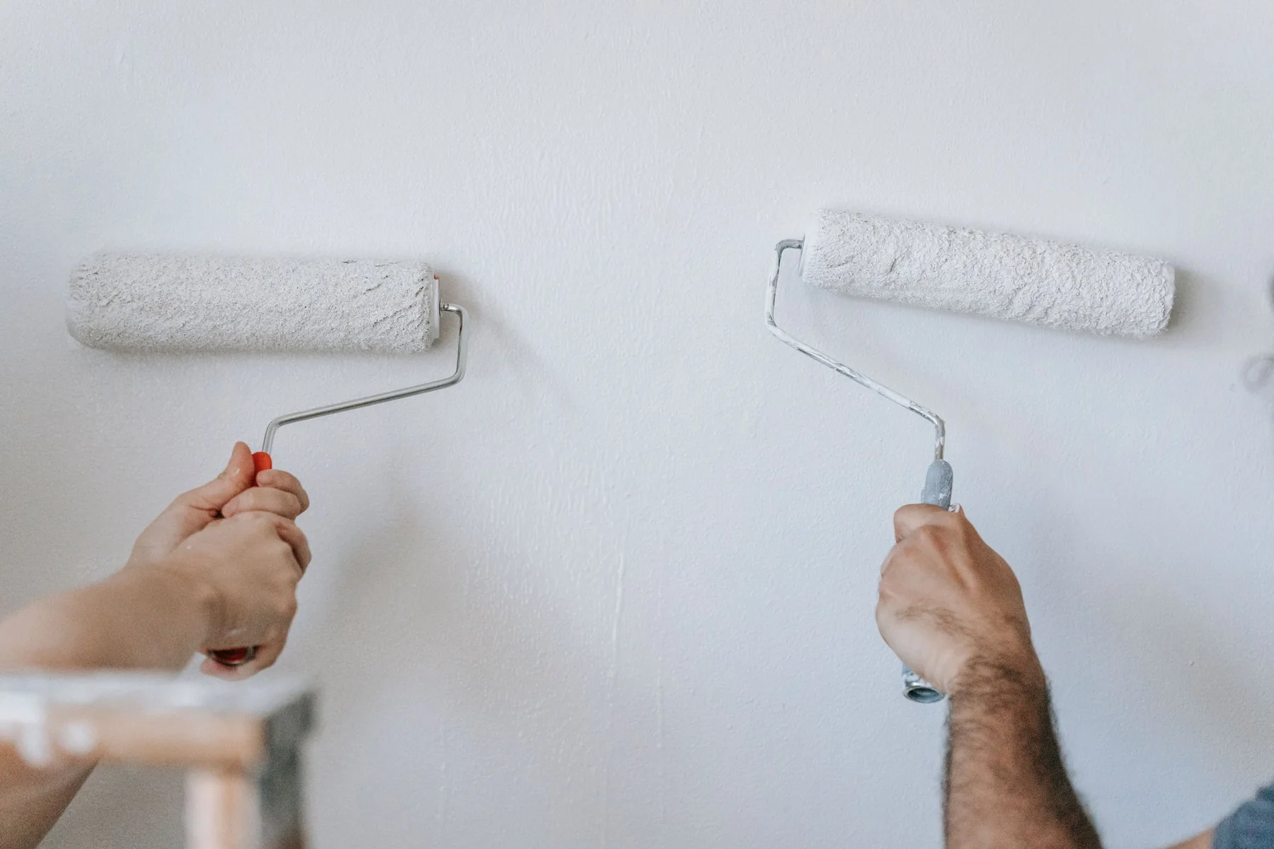 Painters applying a fresh interior wall finish