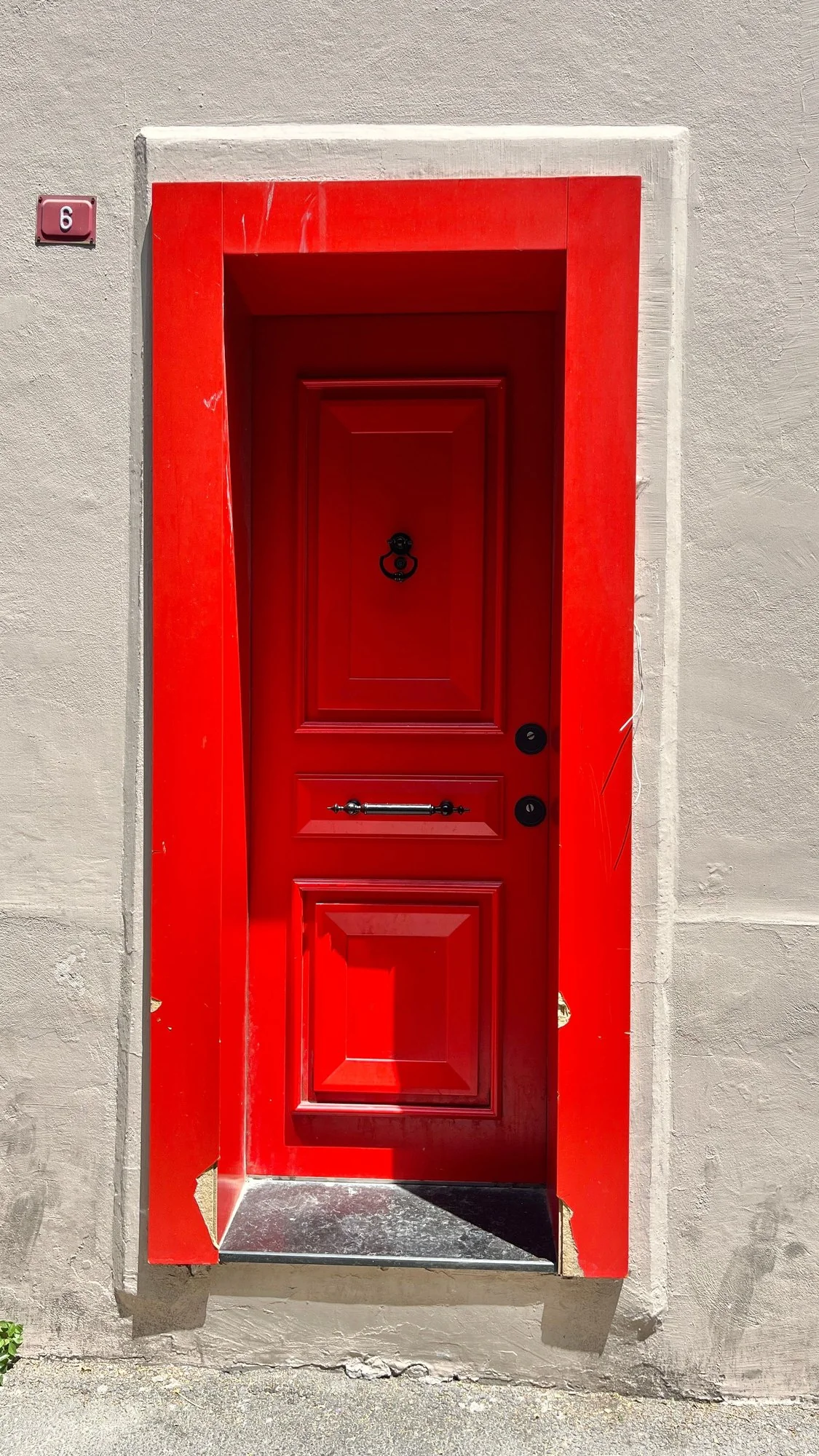 Freshly painted entry door and stucco exterior